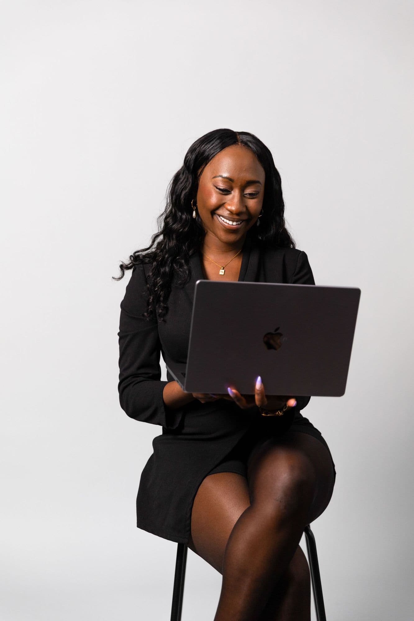 A smiling businesswoman working on a laptop